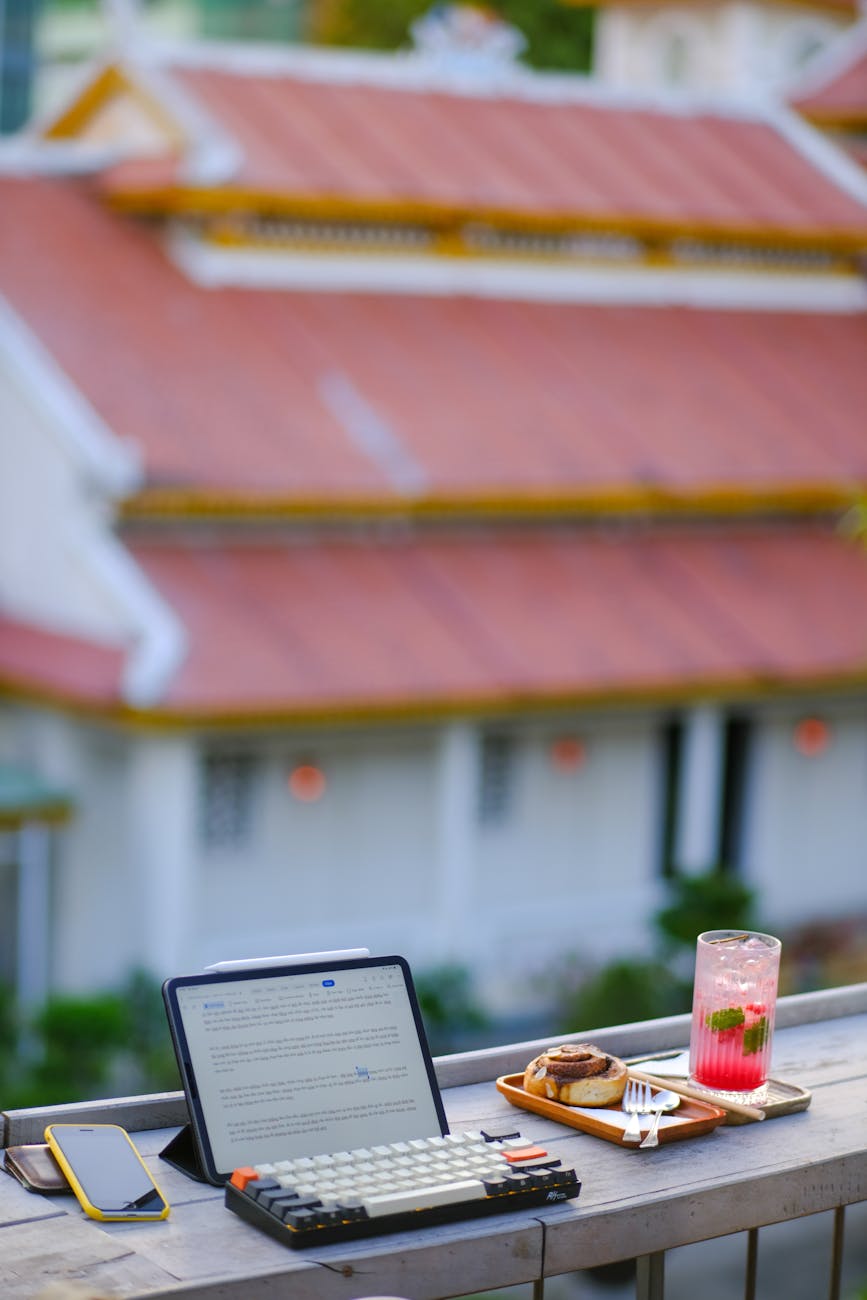 Close-up of a traveler comparing award charts and cash fares on a laptop, notes and boarding pass nearby.